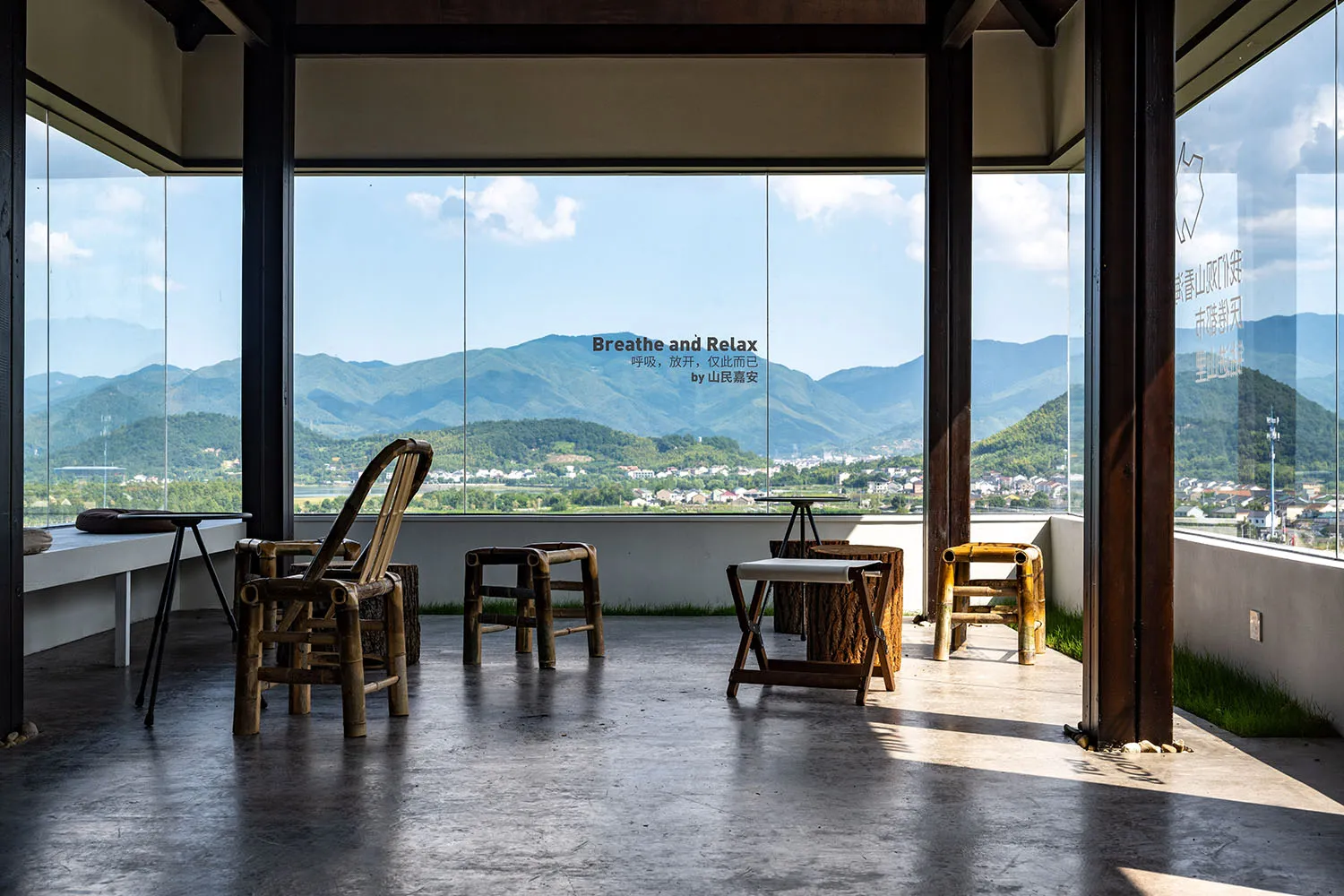 Cozy mountain retreat with natural stone walls, wooden furniture, and a large window overlooking the surrounding mountains