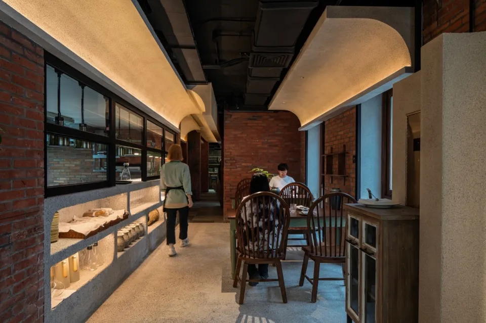 Cozy cafe interior with multiple wooden chairs and tables, creating a warm atmosphere for social gatherings