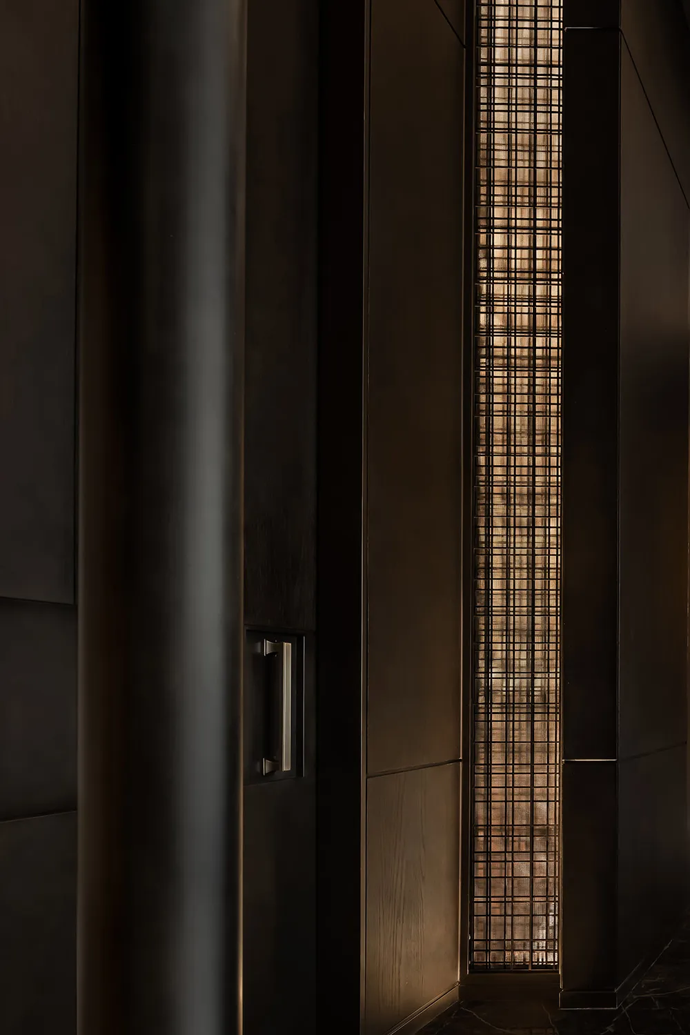 Wooden hallway with a metal grate covering a window, two doors on either side, and a cozy atmosphere
