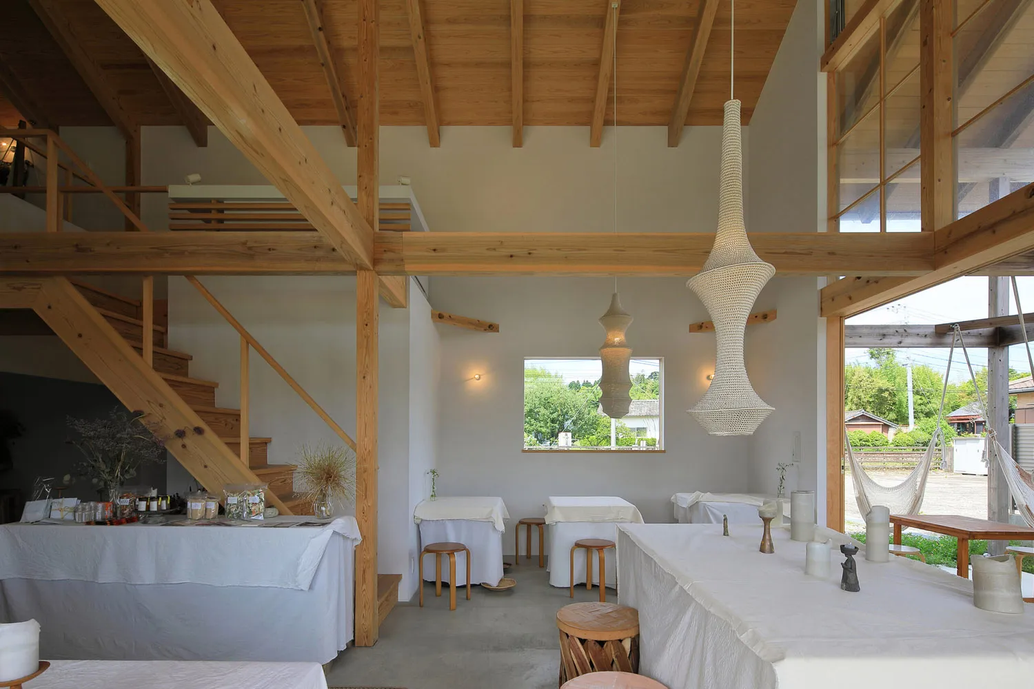 Open living and dining area with wooden floors, white walls, and a warm atmosphere