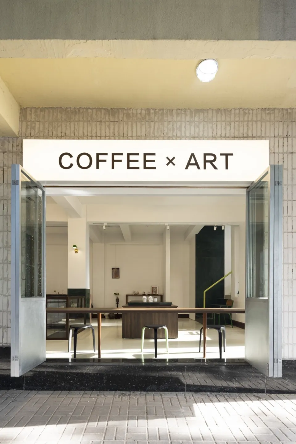 Modern interior design showroom with a coffee shop and art gallery concept, featuring chairs, tables, and a blend of modern and inviting atmosphere