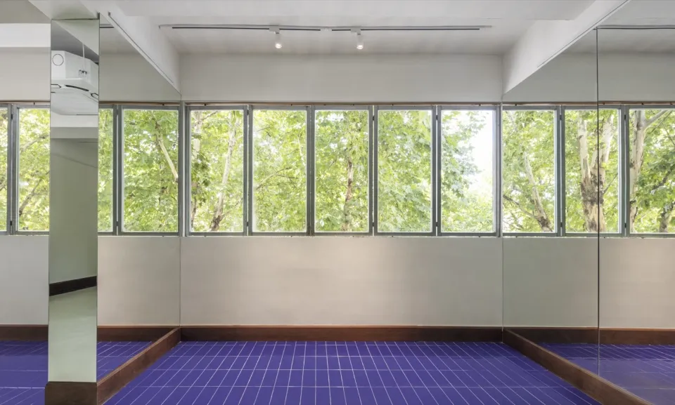 A bright and airy lobby with white walls, large windows, and natural light pouring in