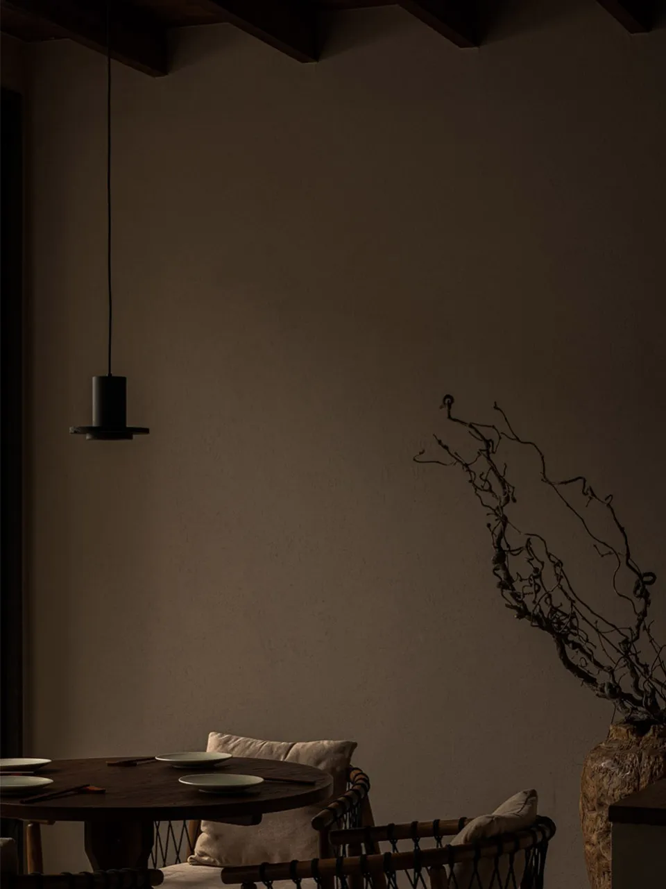 A cozy living room with a wooden dining table surrounded by chairs, creating a warm and inviting atmosphere