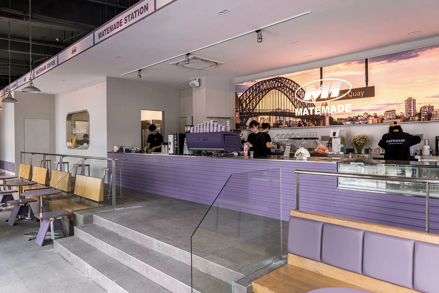 A restaurant interior with a purple countertop, natural light, and comfortable seating for dining