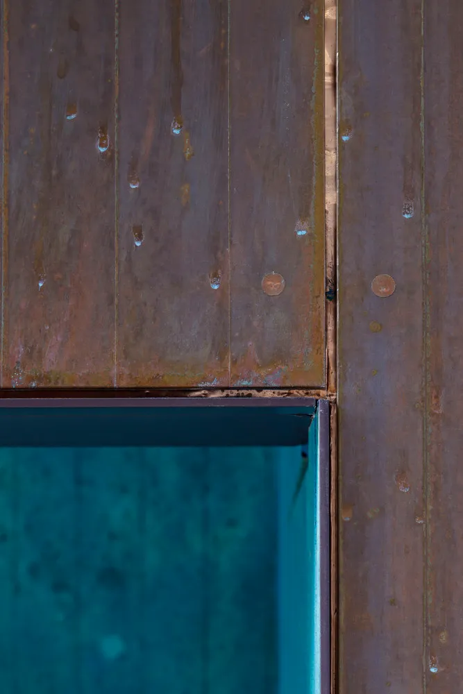 Old wooden wall with weathered planks, rust stains, and visible nails
