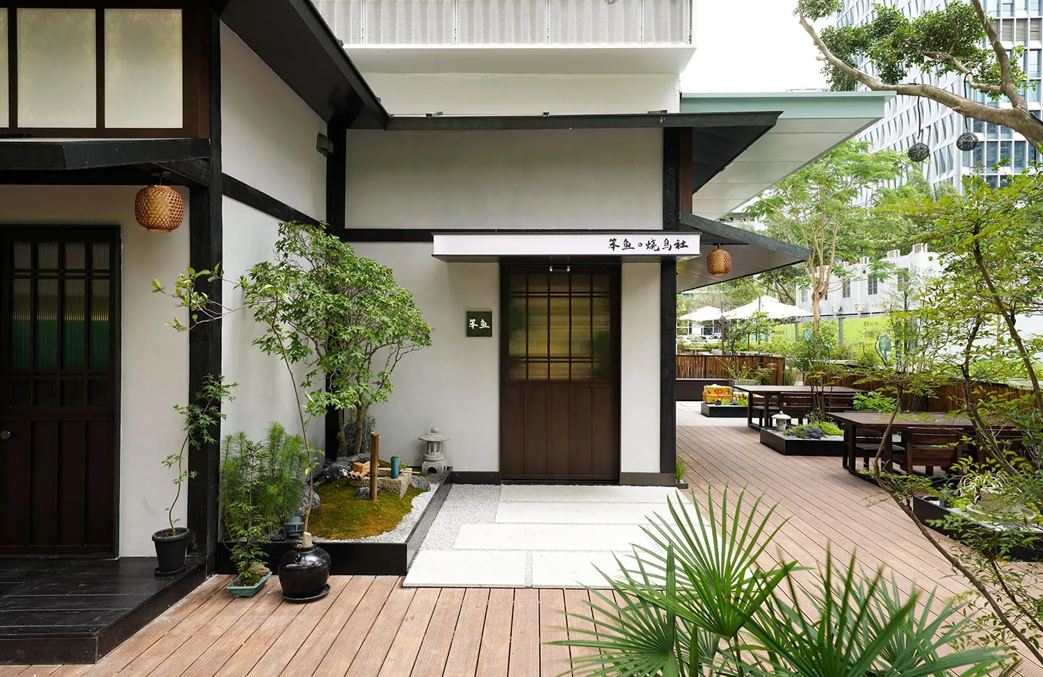 Asian-style house with a wooden deck, potted plants, and umbrellas, creating a calm and inviting atmosphere