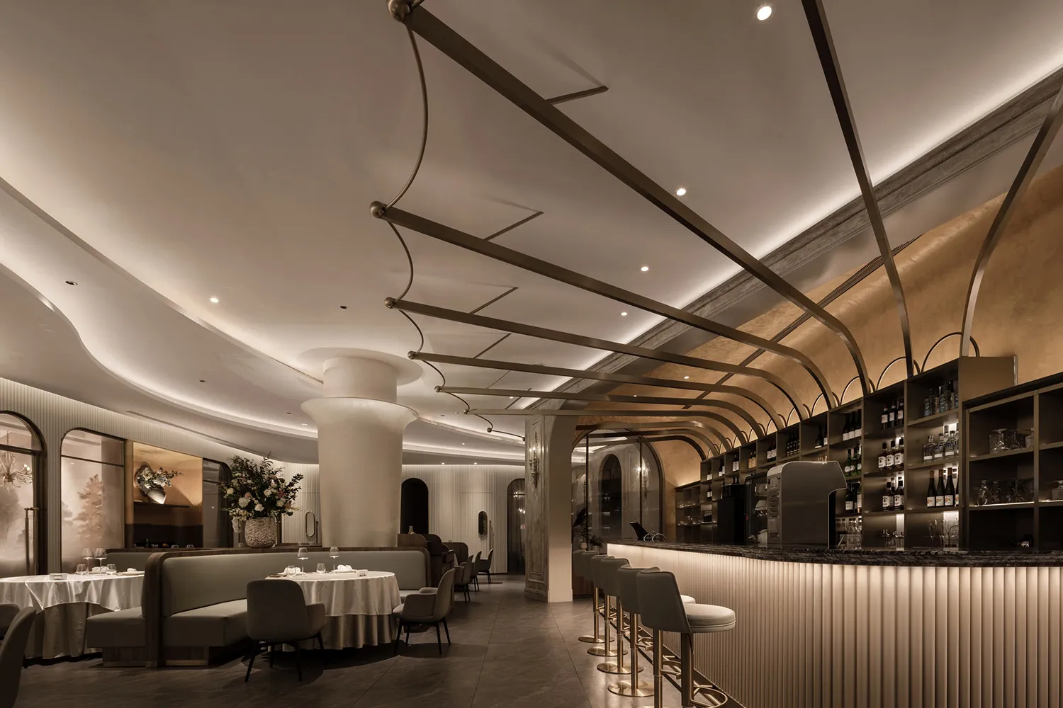 Sophisticated restaurant interior with a bar area, chairs, tables, and wine glasses, creating an inviting atmosphere