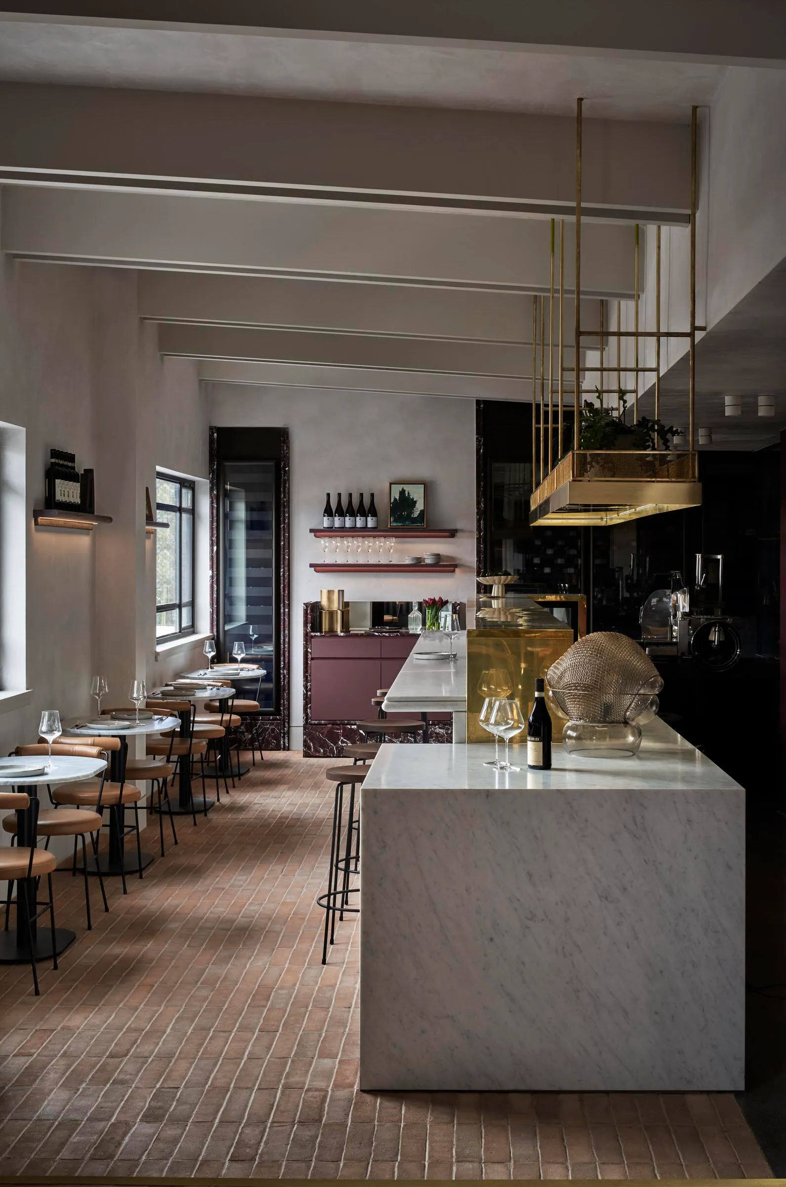 elegant restaurant interior with a marble bar, wine glasses, and wine bottles displayed in a modern and stylish environment