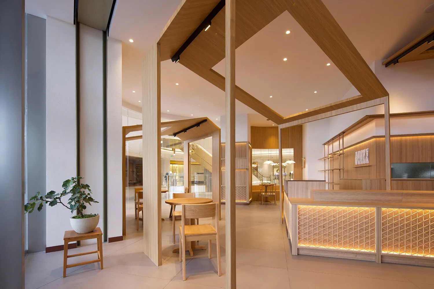Open restaurant interior with wooden tables, chairs, and flooring, creating a warm and inviting atmosphere