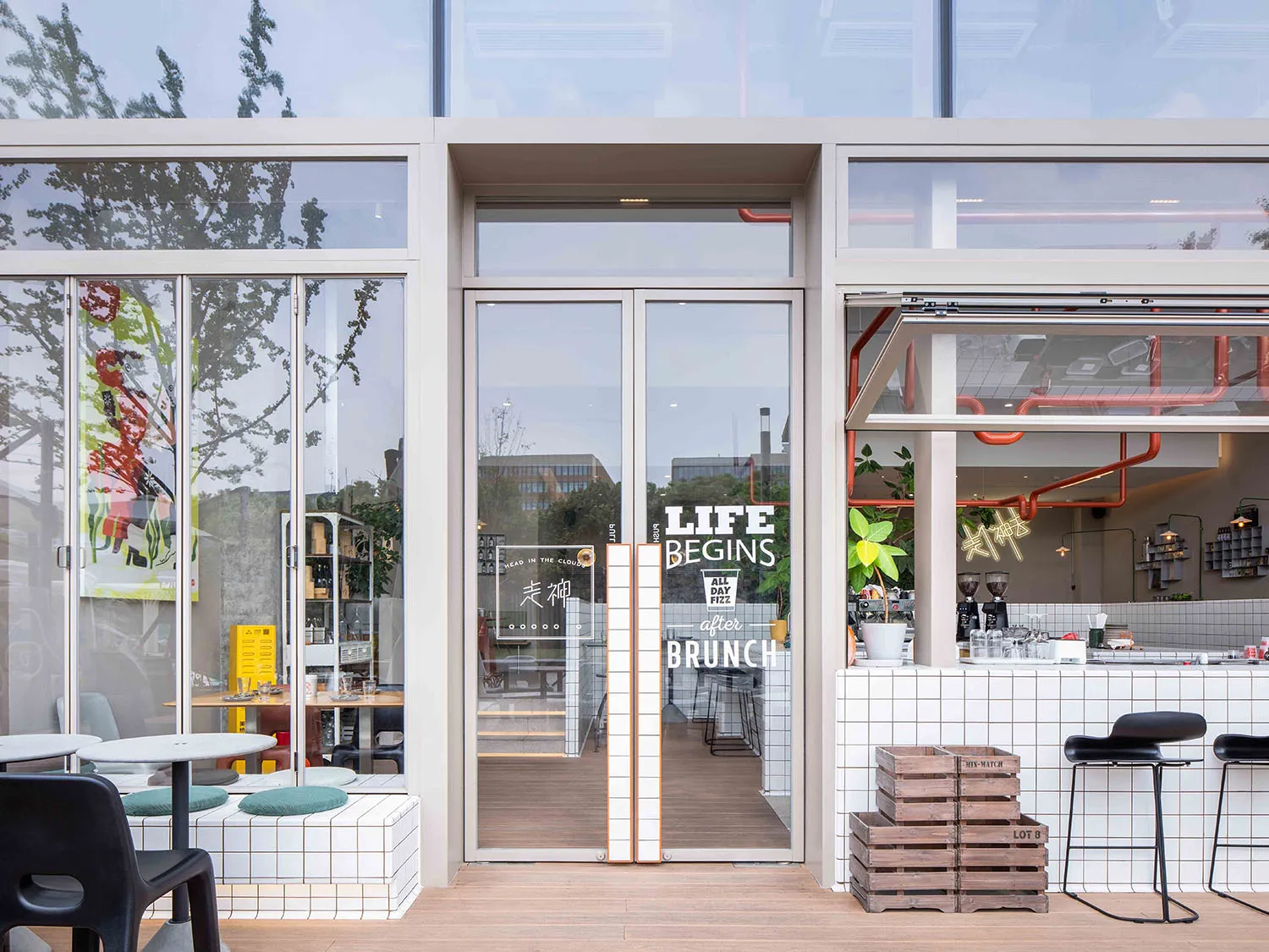 Inviting restaurant space with a wooden floor, chairs, and a potted plant, perfect for dining or coffee