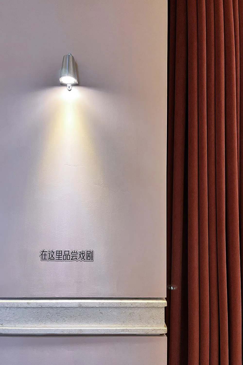 A modern sign with Chinese characters on a concrete wall, suggesting a contemporary Asian-inspired design