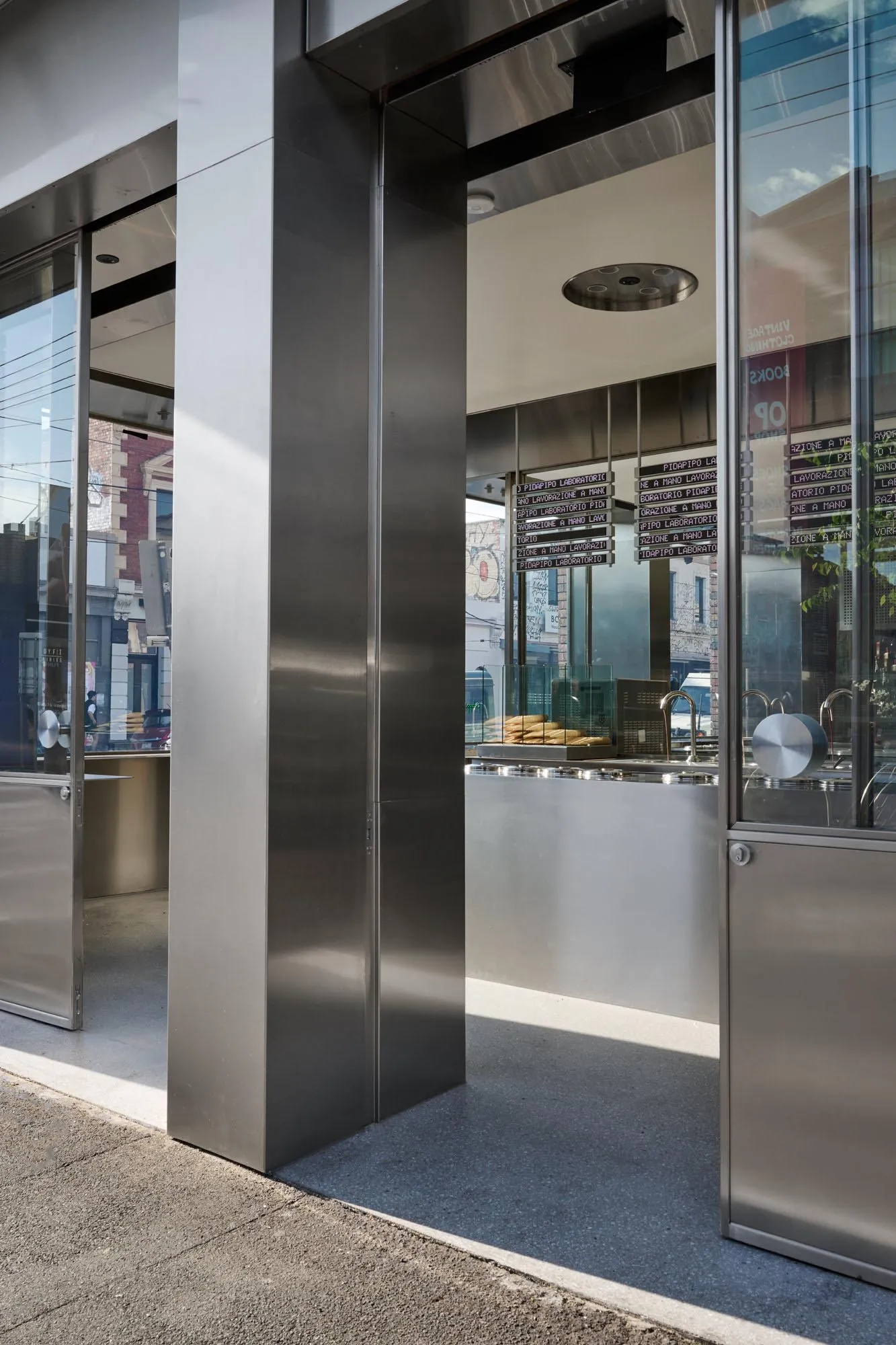 Industrial kitchen with a steel column, modern countertops, and well-organized storage and preparation space