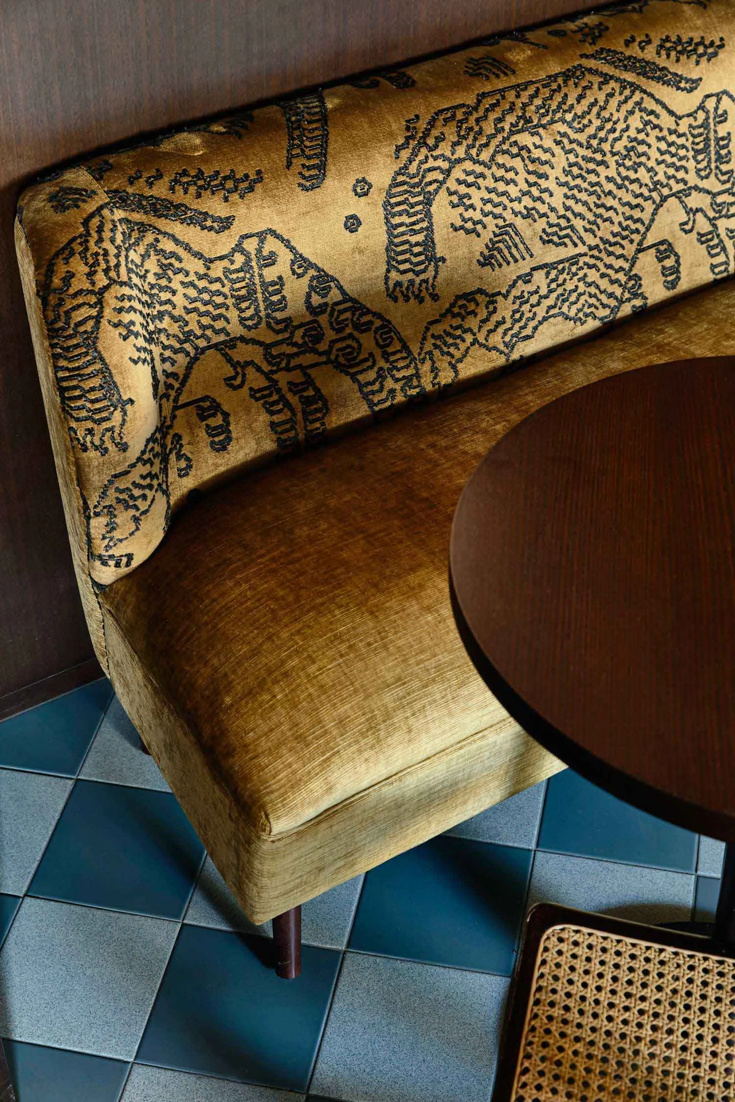 A cozy living space with a leather sofa and a wooden dining table, set against a neutral background