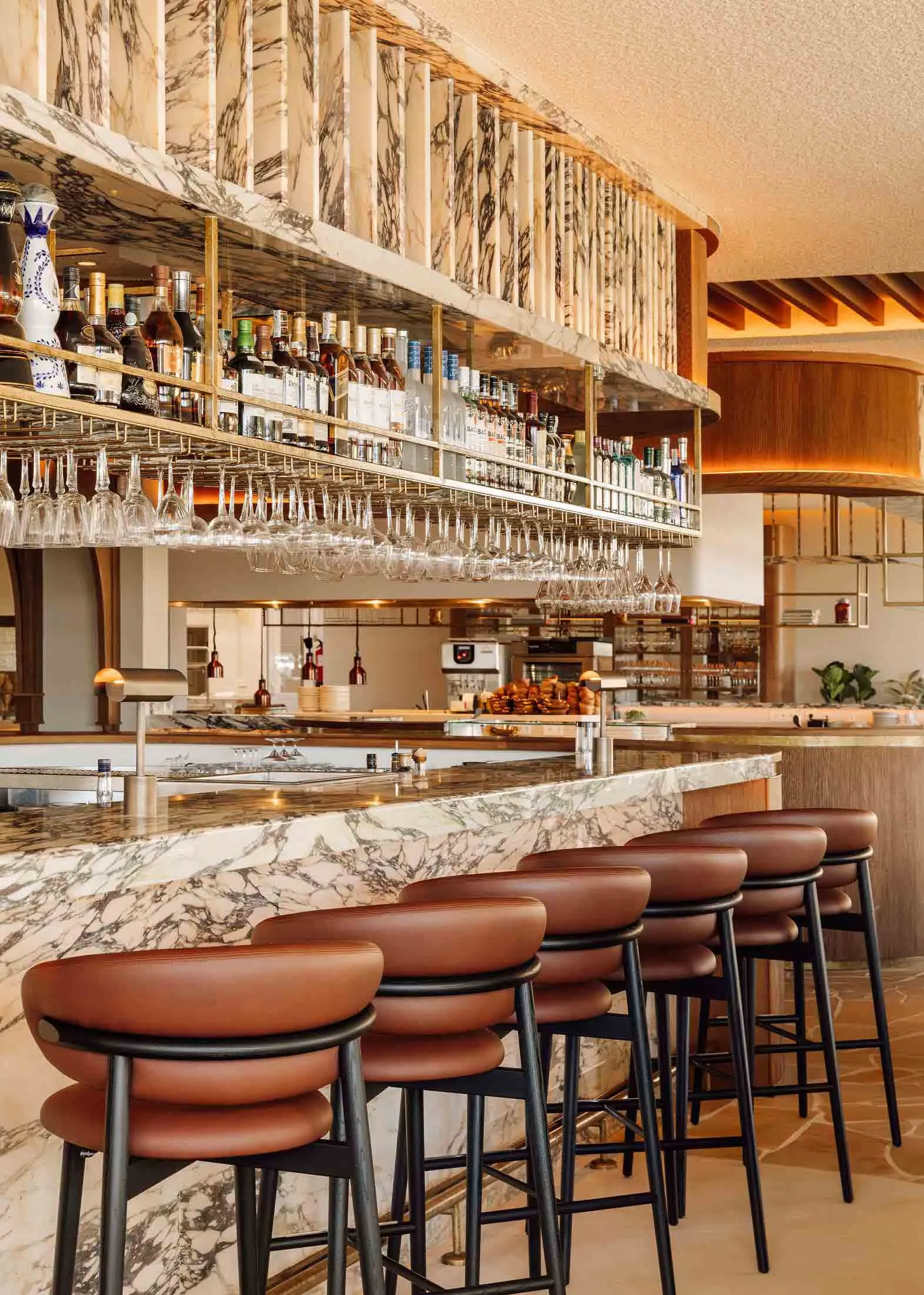 Elegant restaurant interior with a wooden bar, wine glasses, and a sophisticated atmosphere
