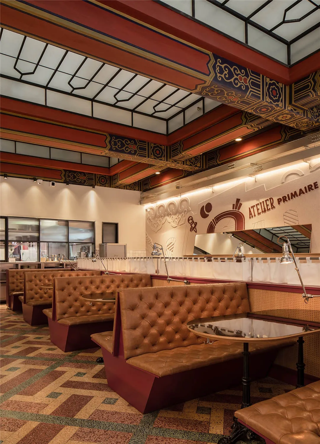 A restaurant interior with leather couches and dining tables, multiple chairs, and an inviting atmosphere
