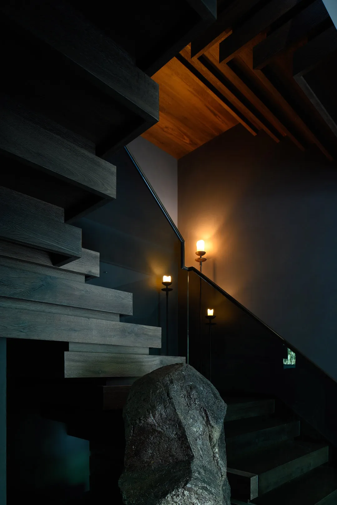 A darkened room with two sets of wooden stairs leading to different levels, creating a mysterious atmosphere