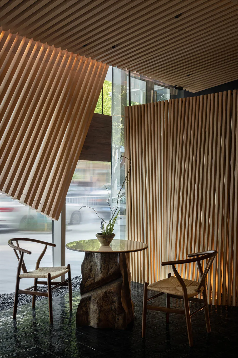 Inviting restaurant interior with wooden walls, tables, and chairs, set against a backdrop of a busy urban street with parked cars