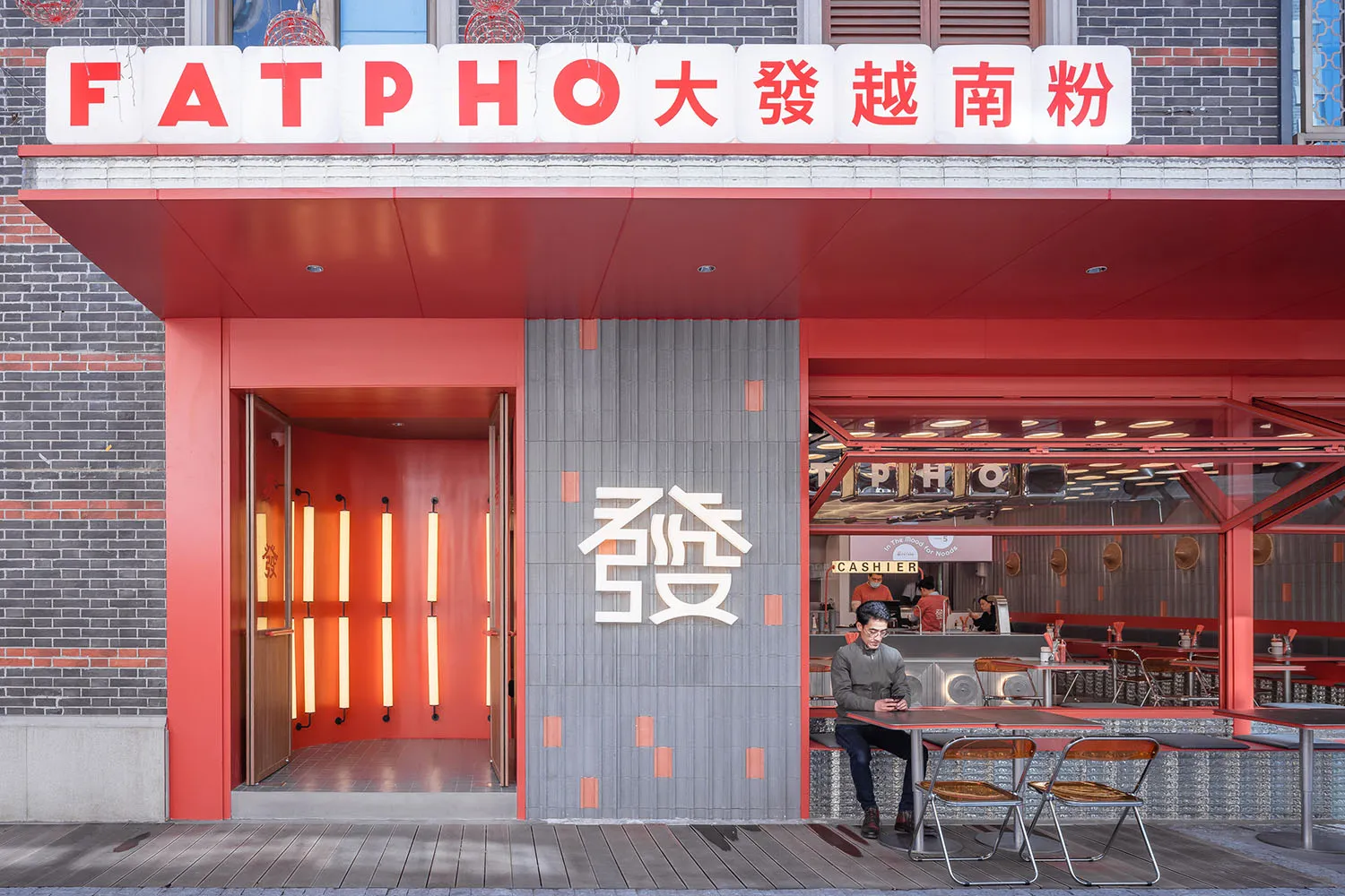A warm and inviting Asian restaurant with red walls, wooden furniture, and a cozy atmosphere