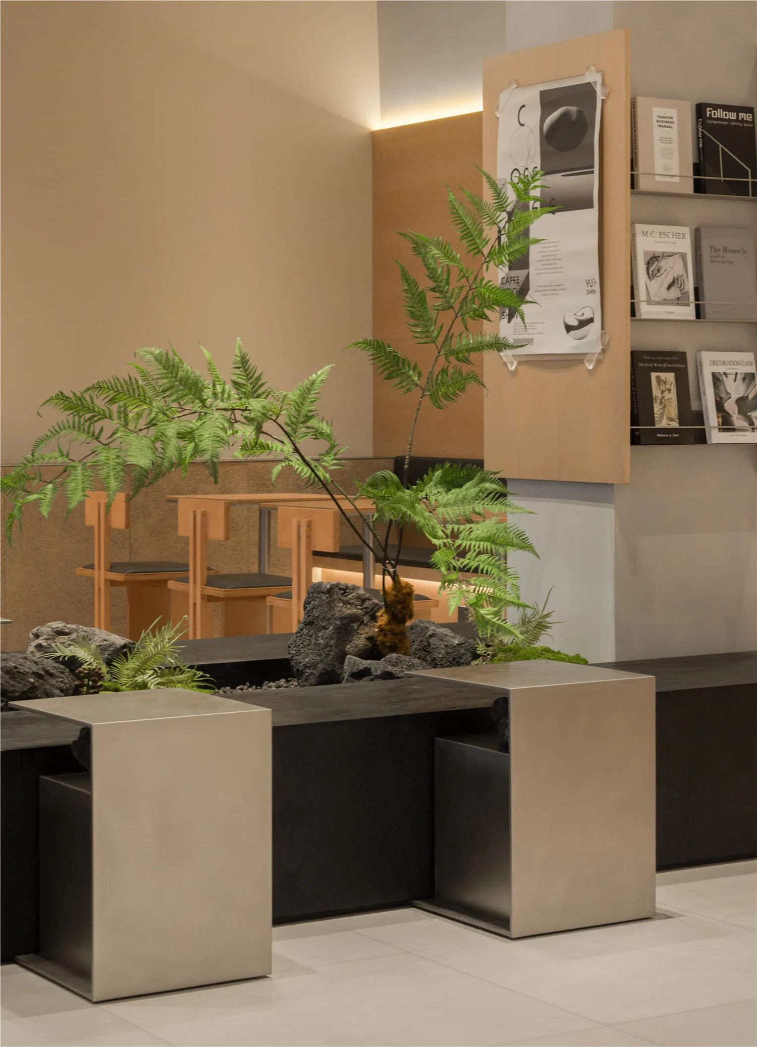 A modern interior design showroom with a large rock garden, potted plants, and comfortable seating arrangements