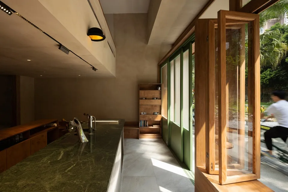 A warm and inviting kitchen with a bookshelf, sink, and doorway to the outdoors