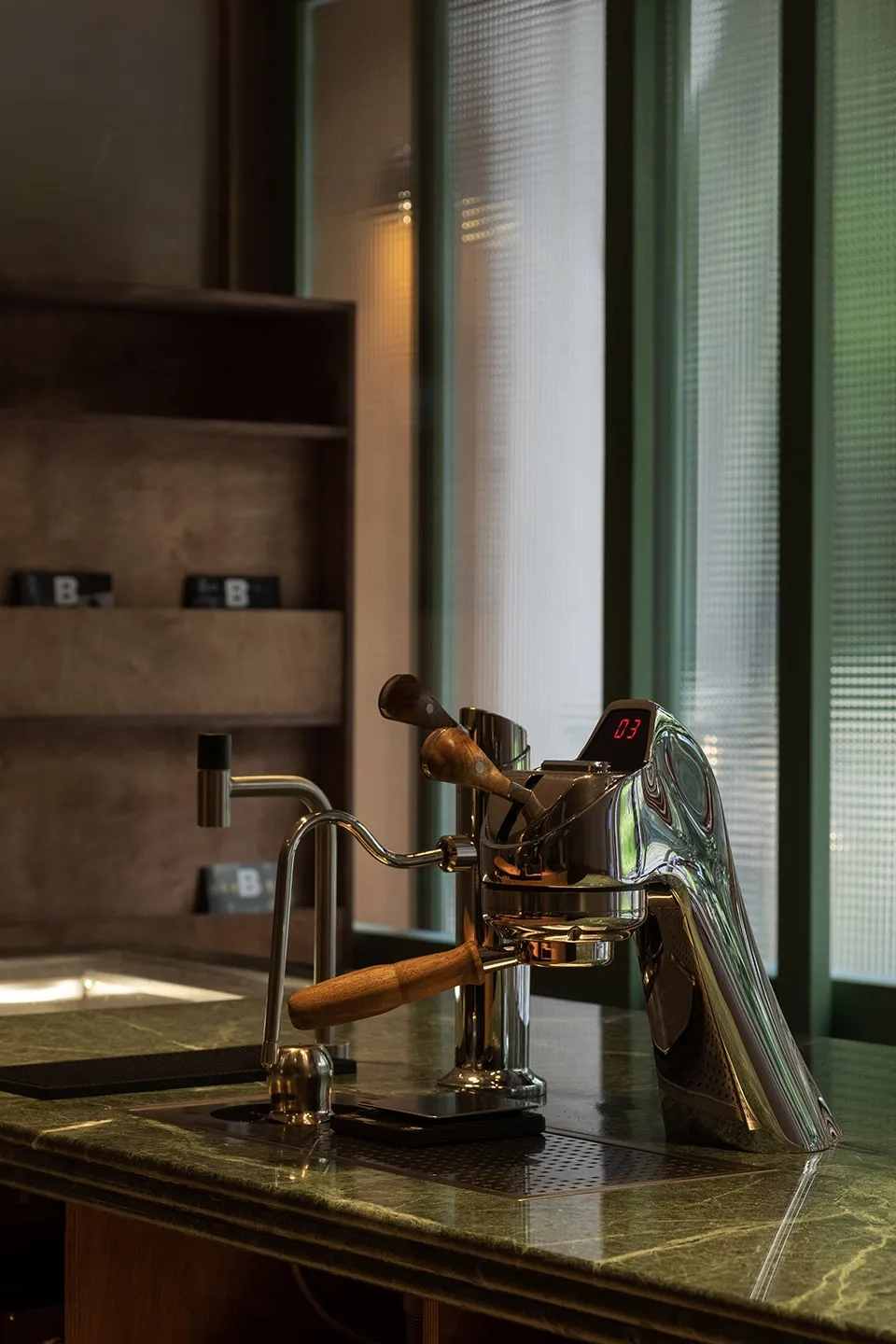 A well-organized kitchen area with a coffee maker, two cups, and a countertop