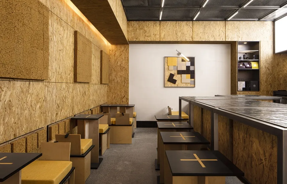 Warm and inviting cafe with wooden walls, tables, and chairs, designed for a large number of guests