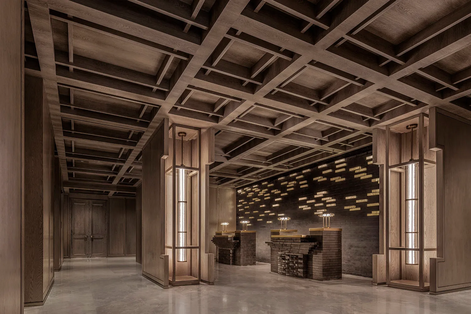A hotel lobby with a large wooden structure, two lamps, and an elegant atmosphere