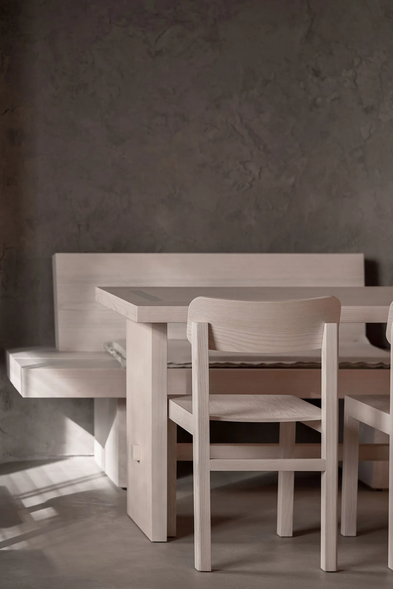 Empty dining area with wooden tables and chairs, creating a calm and inviting atmosphere