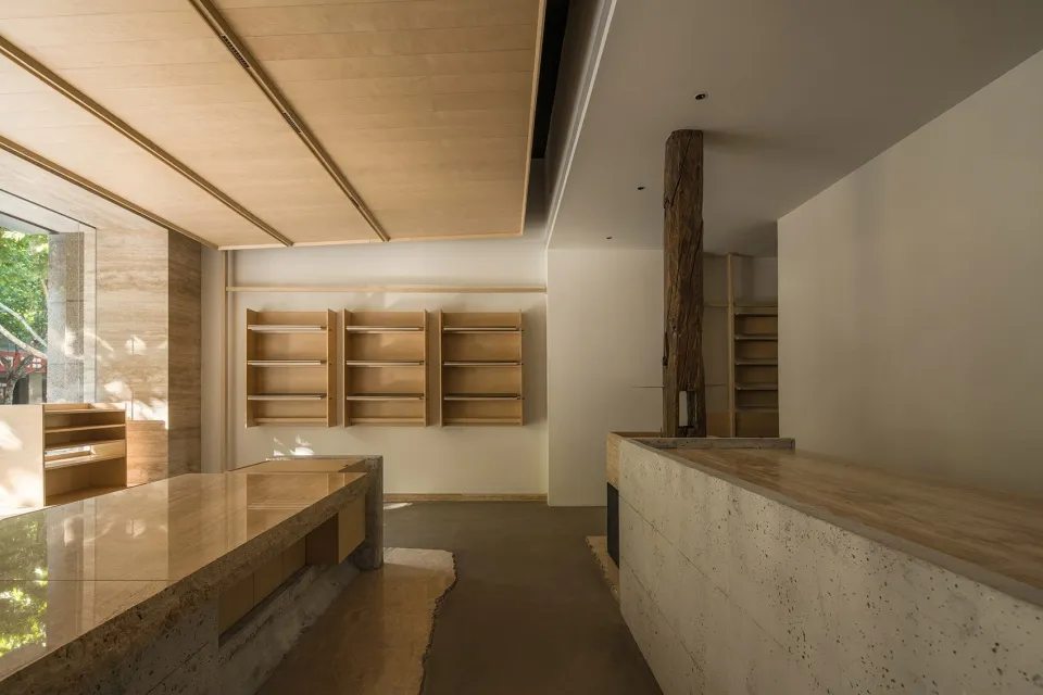 Modern kitchen with wooden cabinets and shelves, well-lit with natural light from windows
