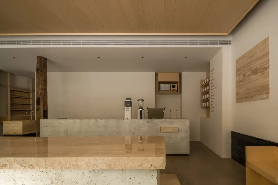 A modern coffee shop interior with a marble counter, two coffee machines, and two cups, featuring a stylish and luxurious atmosphere