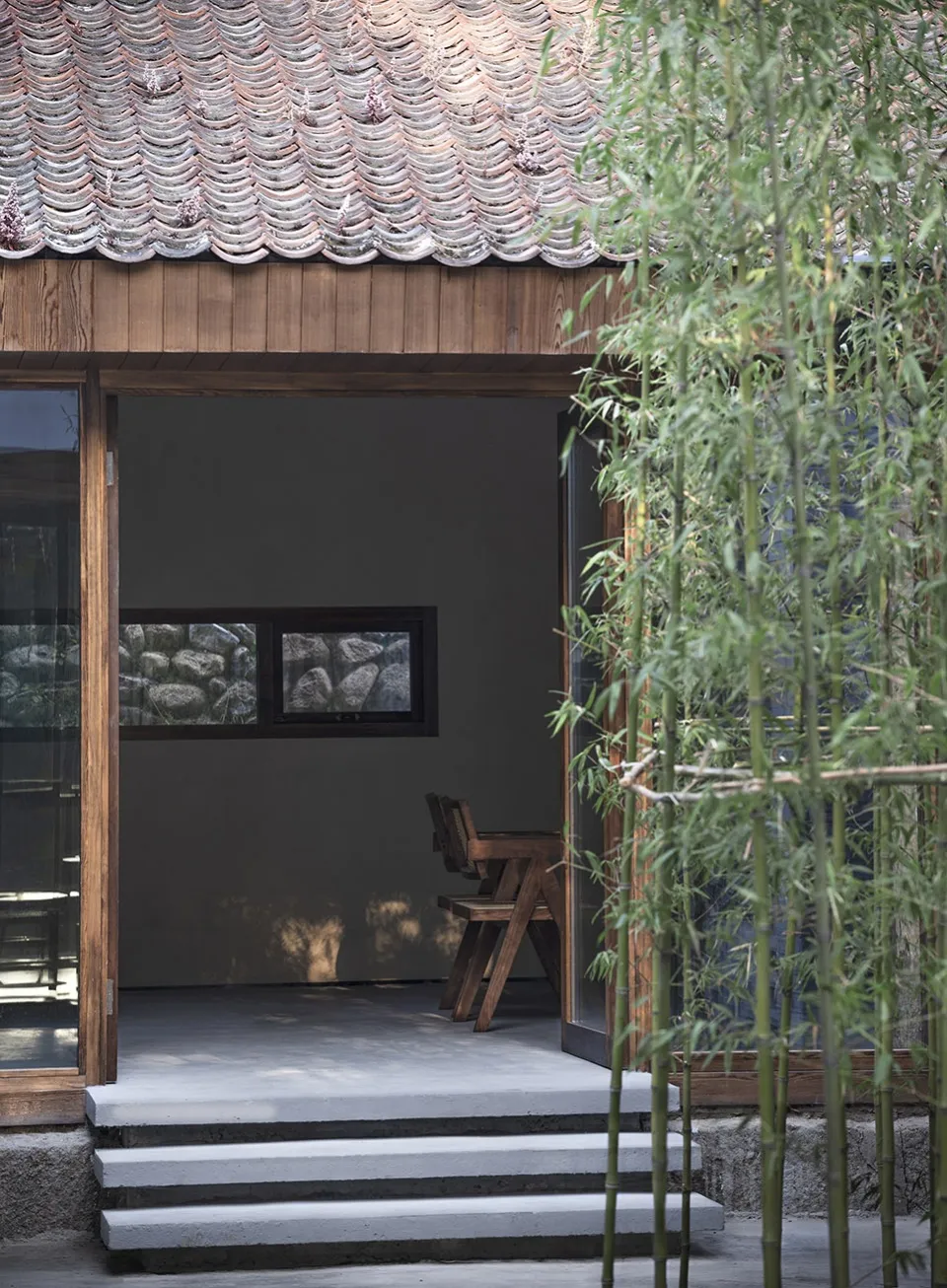 A small room with a wooden floor and a chair, creating a calm and inviting atmosphere