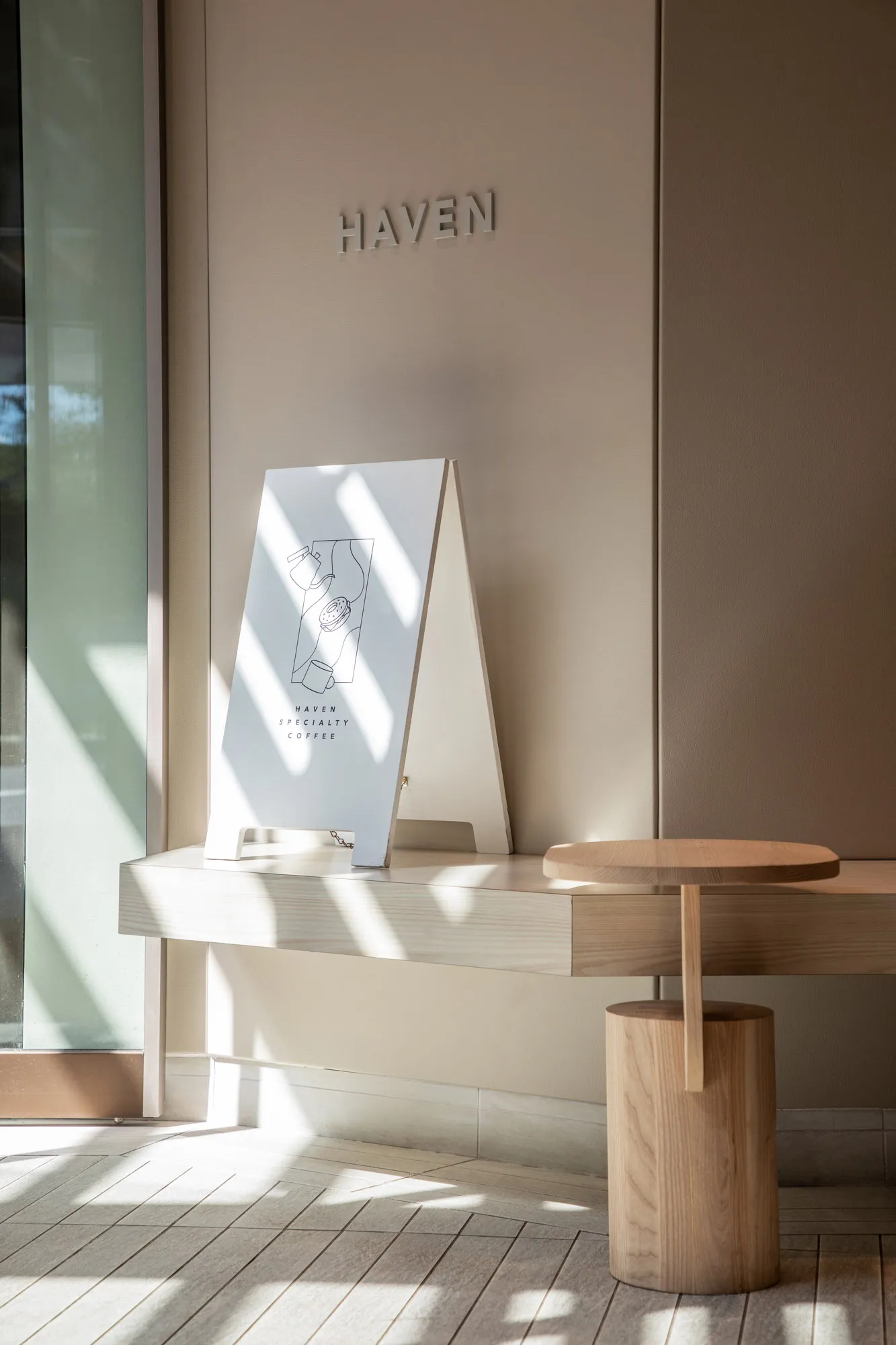 A warm and inviting interior design showroom with a wooden table, two chairs, and a cozy atmosphere