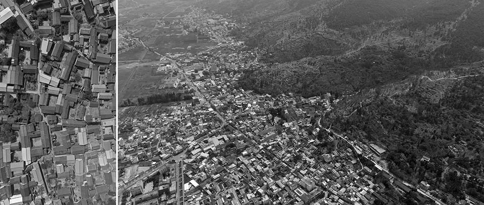 Aerial view of a city with concrete and brick buildings, illuminated by streetlights at night