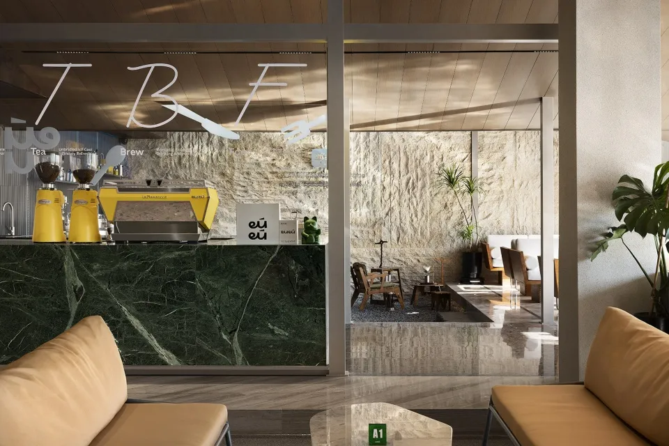 Modern coffee shop interior with a marble countertop, glass door, chairs, and a potted plant