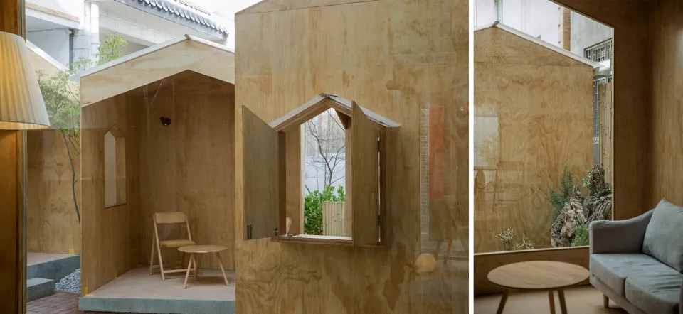 A small wooden structure with a window and a calm, inviting atmosphere, featuring a dining table and chairs