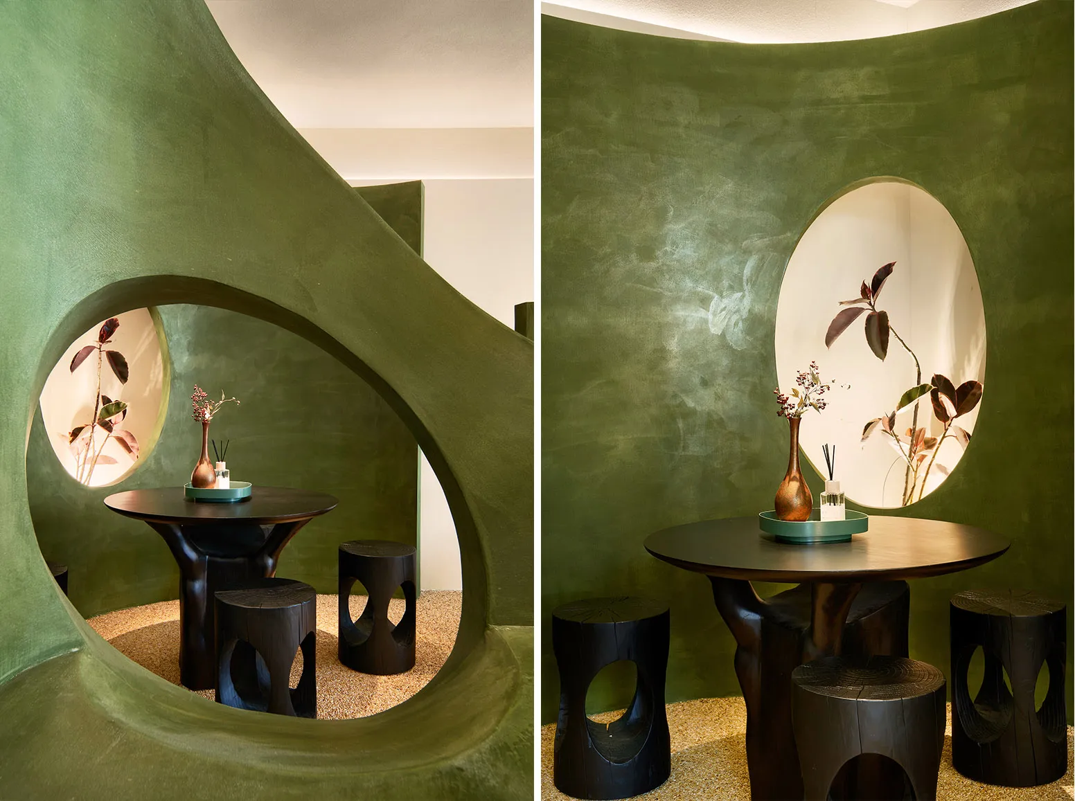 A cozy cafe interior with green walls, potted plants, and dining tables with vases, creating a warm and inviting atmosphere