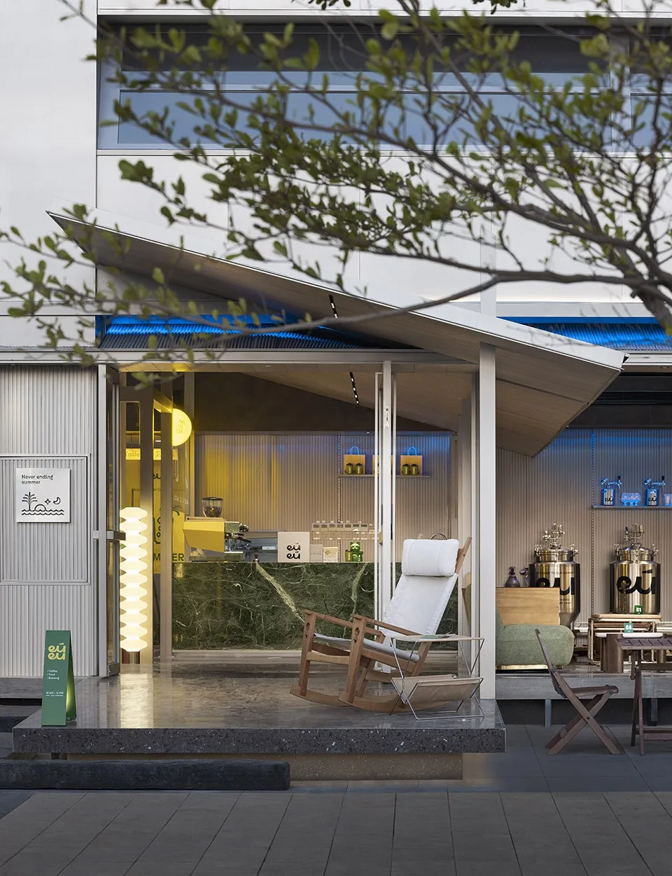 An inviting outdoor cafe with a modern design, featuring a patio area with chairs and dining tables, wood and metal elements, and a relaxed atmosphere