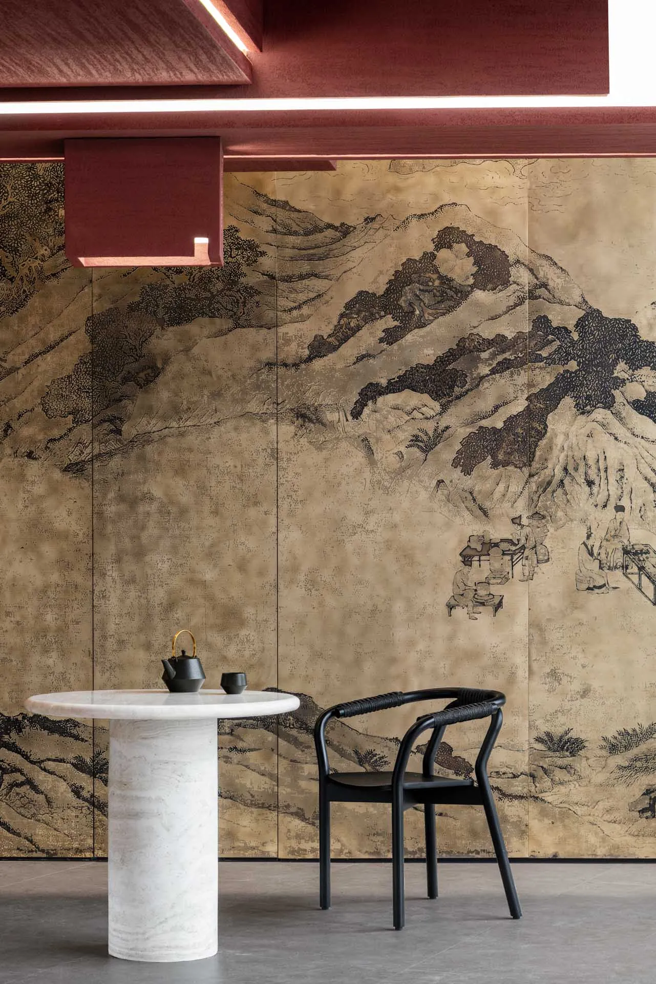 Dining space with a marble table, black chairs, and dark wood elements, designed for relaxation and socializing