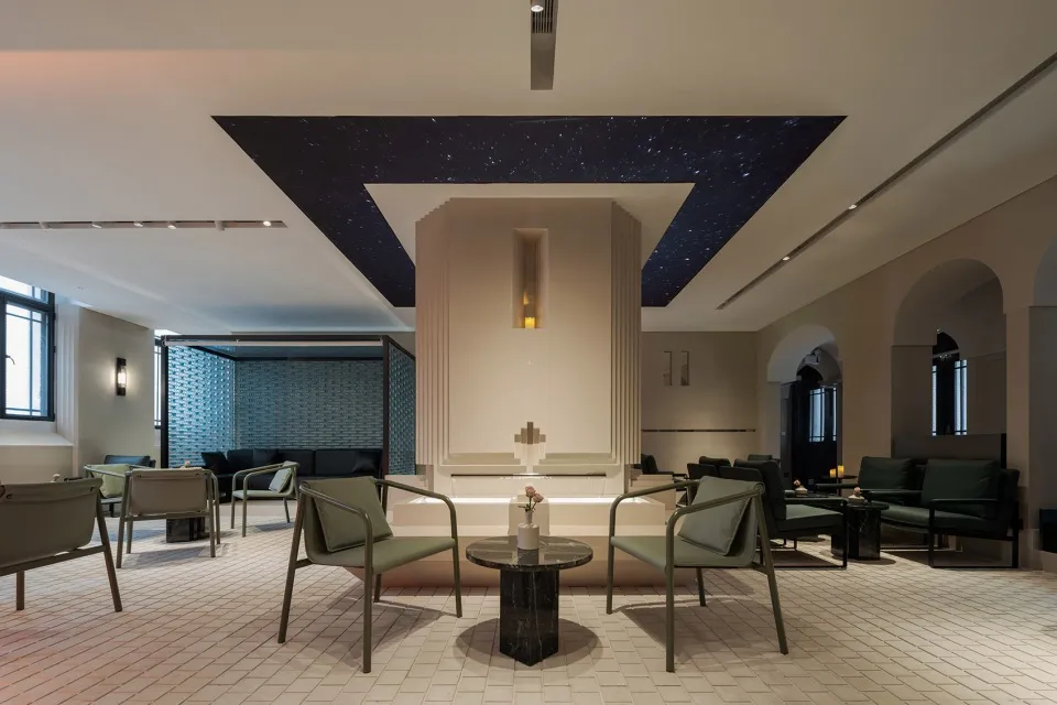A cozy cafe with star pattern walls, comfortable seating, and dining tables