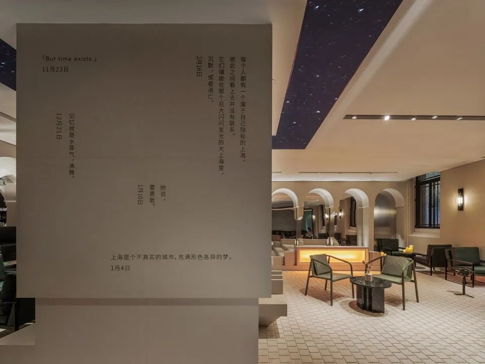 Calm and inviting lobby with stone walls, chairs, and a dining table, perfect for gathering and relaxation