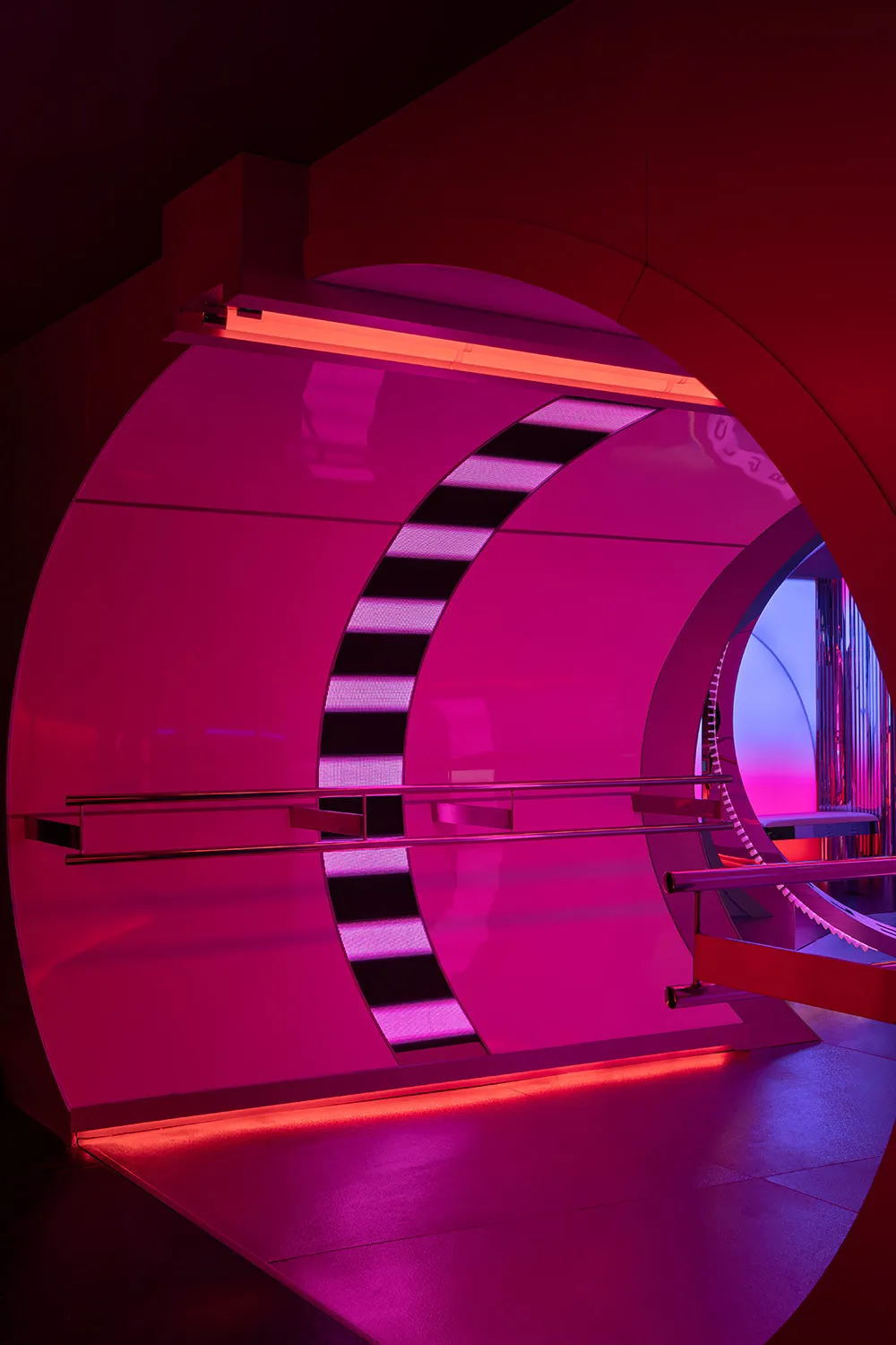 A futuristic room with a pink metal spiral staircase and a purple background