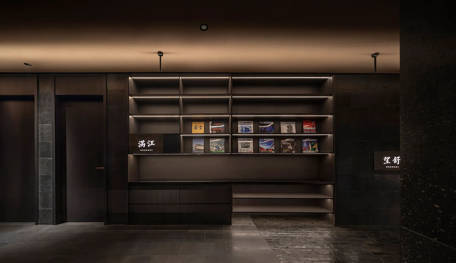 A dimly lit library or store with numerous books arranged on wooden shelves in various sizes and heights, creating a cozy atmosphere
