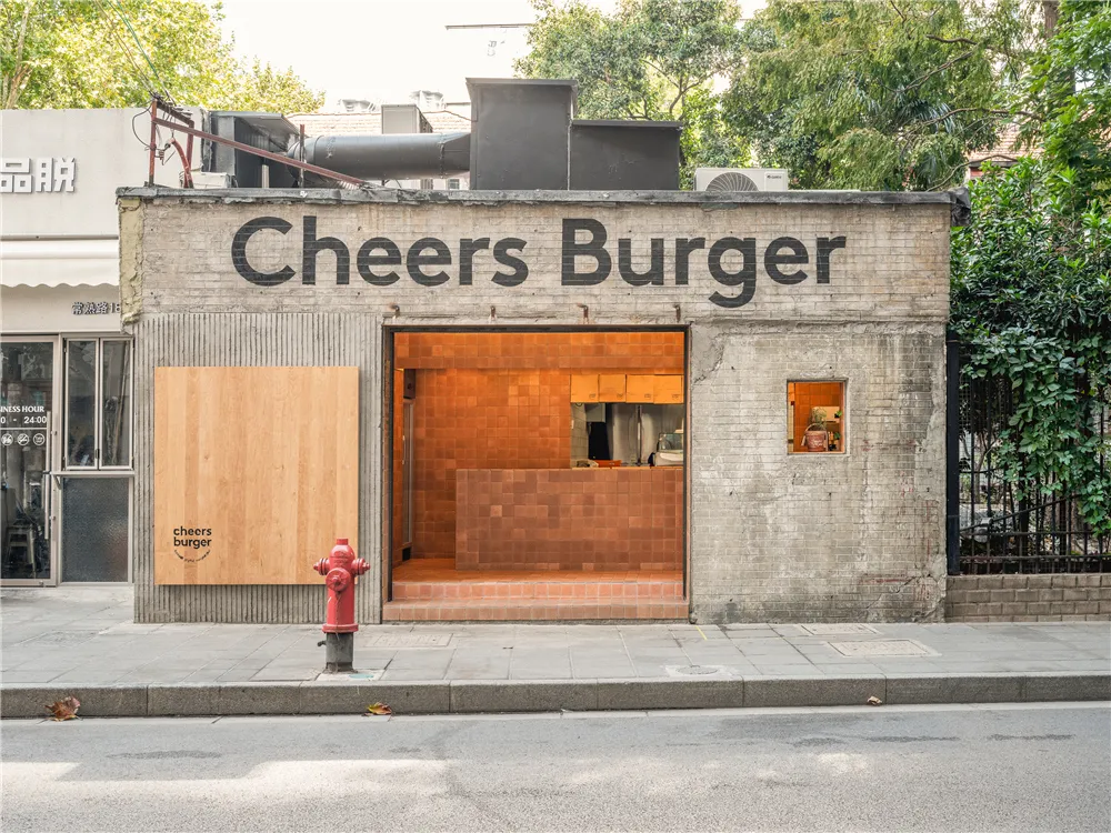 Exterior view of a restaurant with a brick facade, a fire hydrant, and urban surroundings