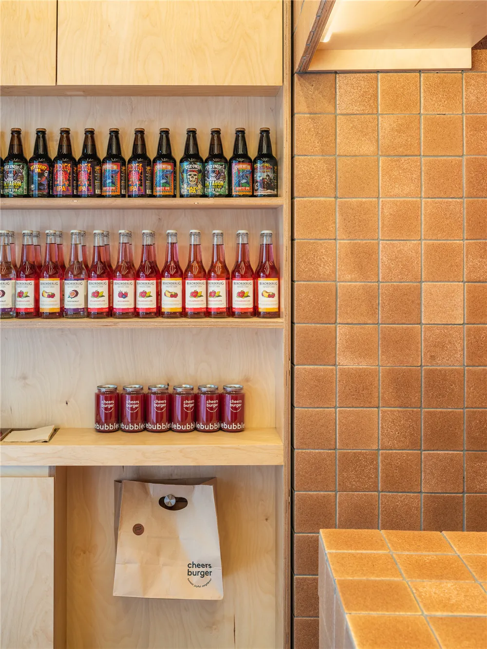 A colorful store display filled with various bottles of drinks, arranged on shelves in a visually appealing way
