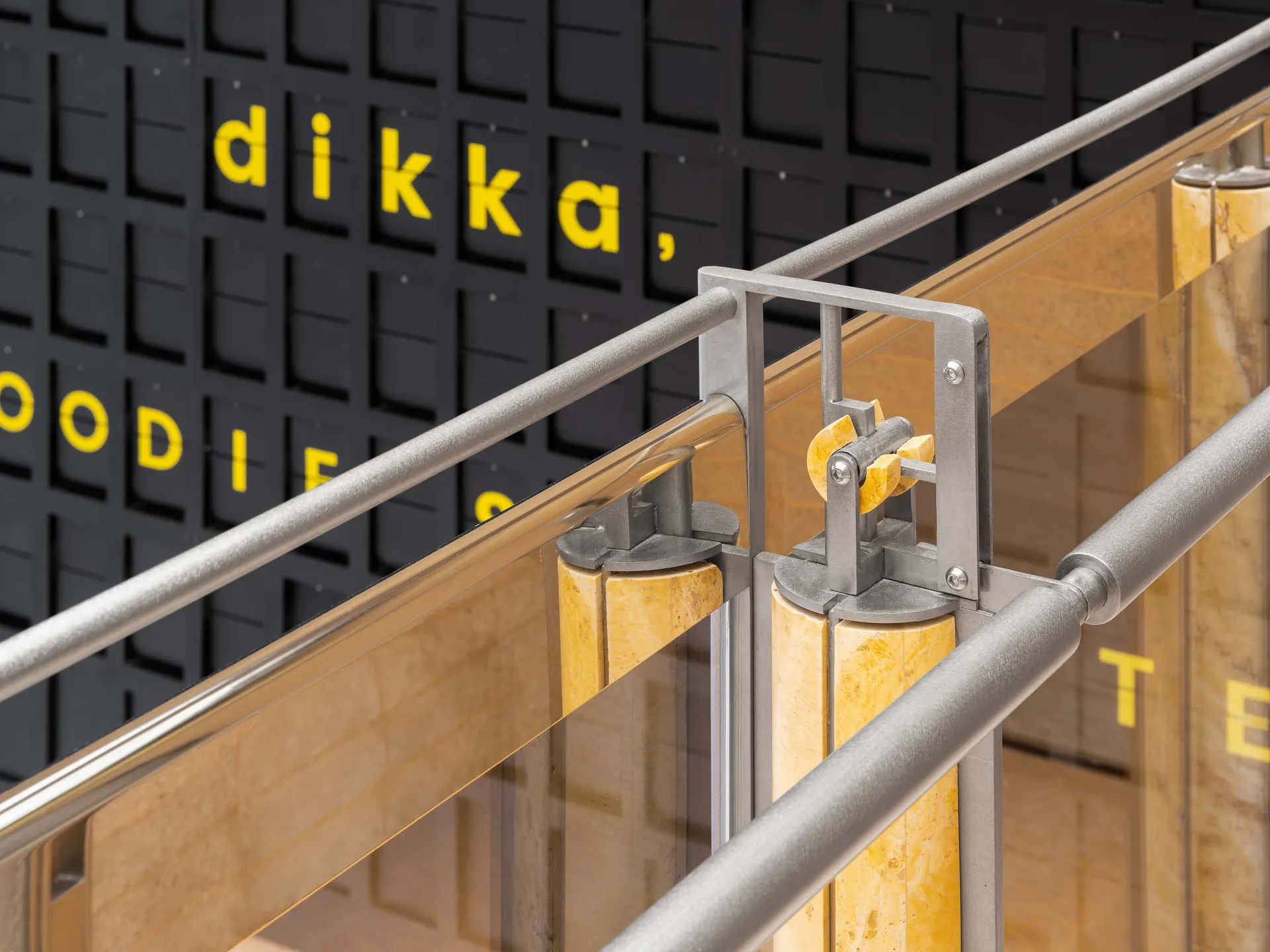 A modern staircase with metal railings on both sides, set against a neutral background