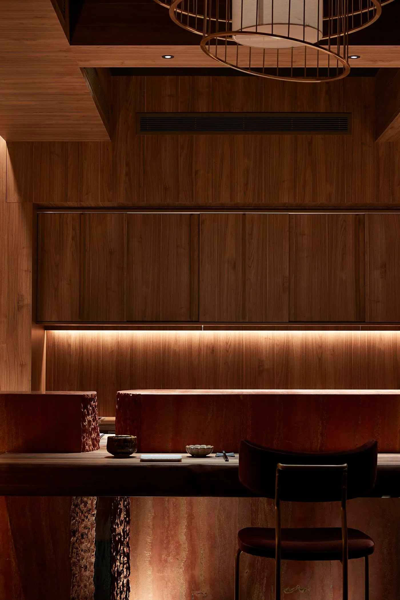 A cozy dining area with a wooden table and chairs, two couches, and a warm atmosphere, perfect for gatherings and meals