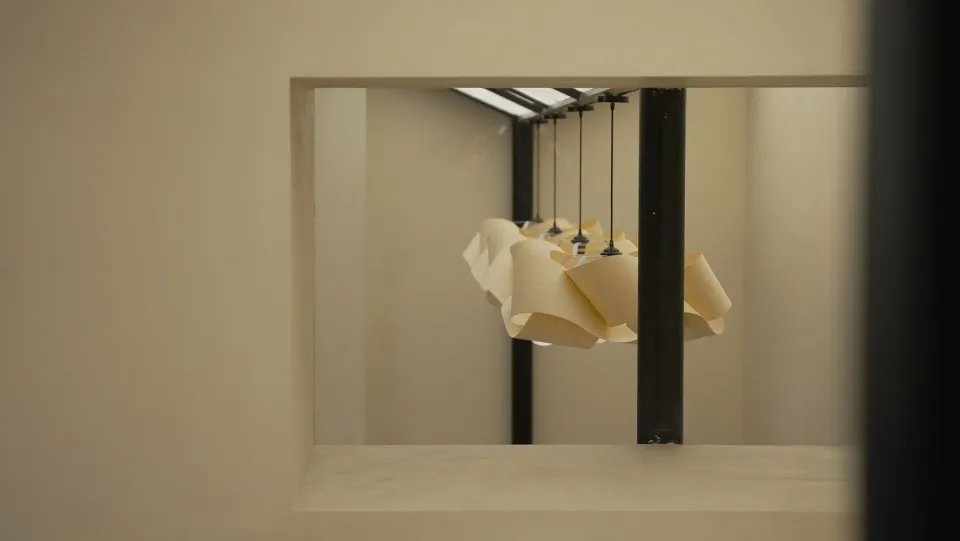 Interior view of a modern room with wooden lighting fixtures suspended at different heights