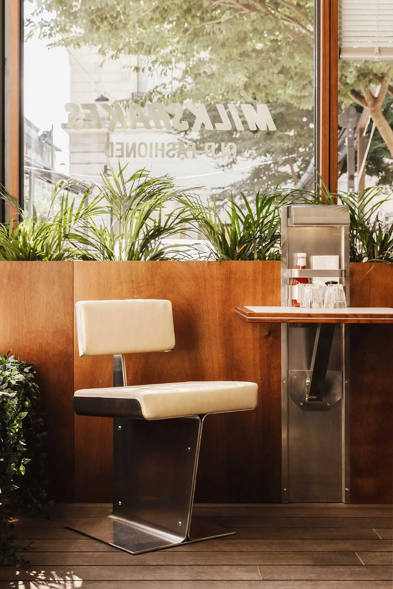 A cozy bar area with a countertop, chair, and potted plants, creating a warm and inviting atmosphere
