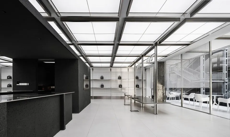Empty modern room with white walls, black cabinets, and well-lit space