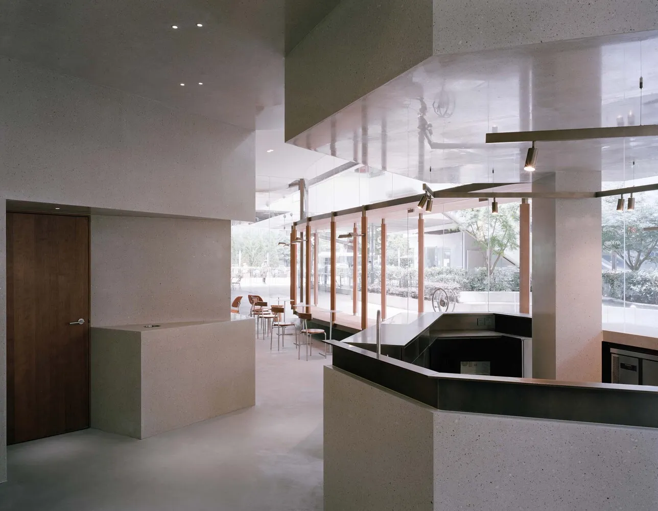 Modern restaurant interior with a large bar area, comfortable seating, and a focus on functionality and comfort